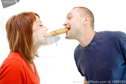 Image of happy couple eating croissant