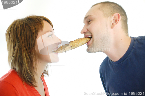 Image of happy couple eating croissant