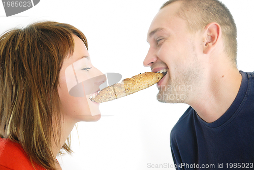 Image of happy couple eating croissant