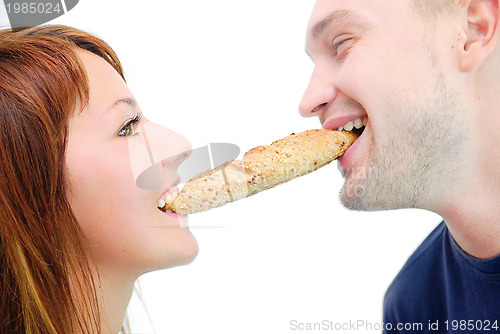 Image of happy couple eating croissant