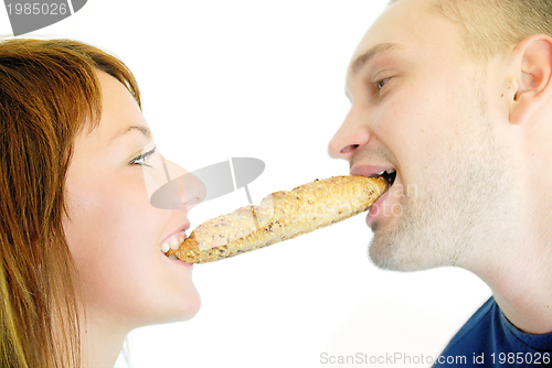 Image of happy couple eating croissant