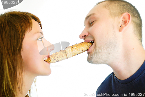 Image of happy couple eating croissant