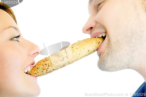 Image of happy couple eating croissant