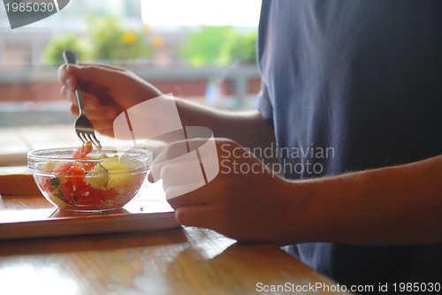 Image of man eating healthy food it an restaurant