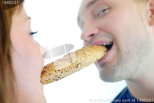 Image of happy couple eating croissant