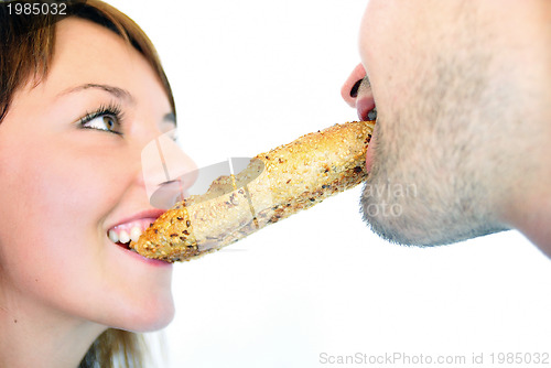 Image of happy couple eating croissant