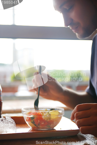 Image of man eating healthy food it an restaurant