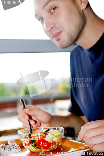 Image of man eating healthy food it an restaurant