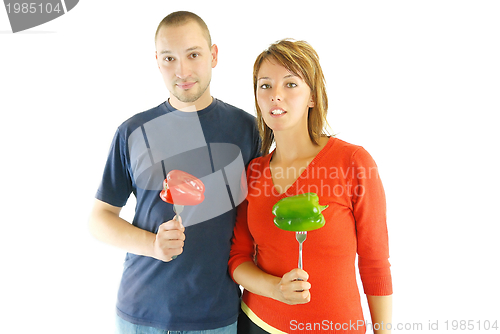 Image of happy couple with peppers isolated