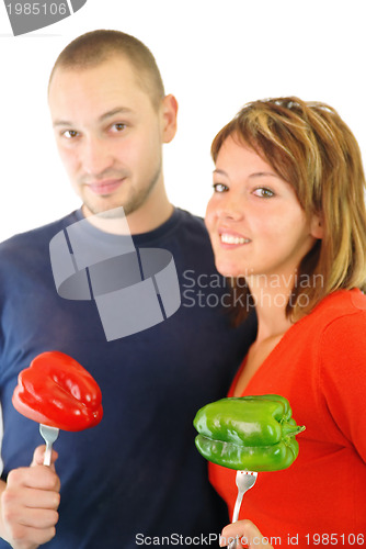 Image of happy couple with peppers isolated