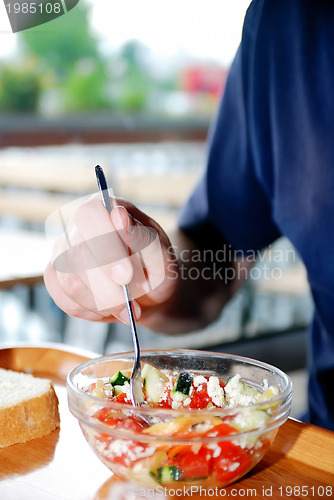 Image of man eating healthy food it an restaurant