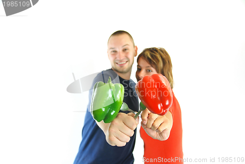 Image of happy couple with peppers isolated