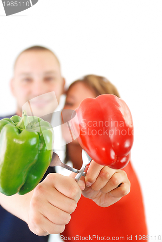 Image of  happy couple with peppers isolated