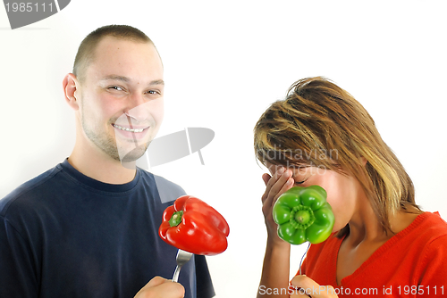 Image of happy couple with peppers isolated