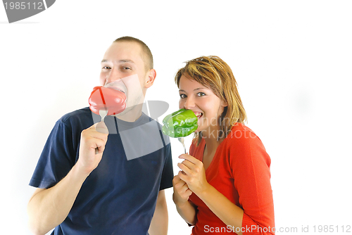 Image of happy couple with peppers isolated