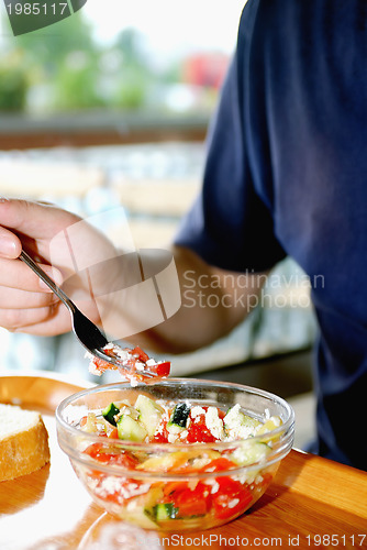 Image of man eating healthy food it an restaurant