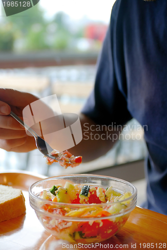 Image of man eating healthy food it an restaurant