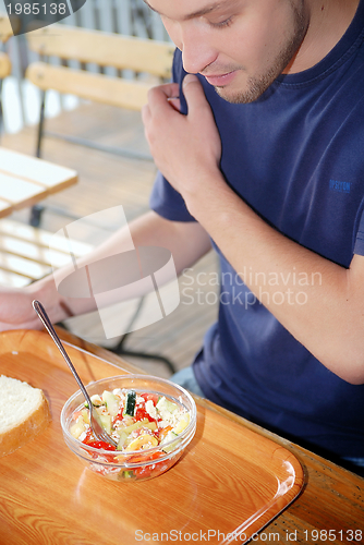 Image of man eating healthy food it an restaurant