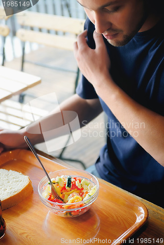 Image of man eating healthy food it an restaurant