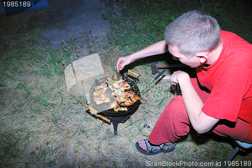 Image of preparing chicken on grill