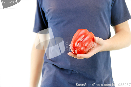 Image of happy couple holding peppers with head