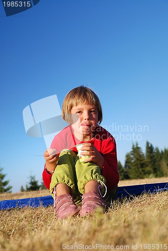 Image of happy girl eating healthy food in nature