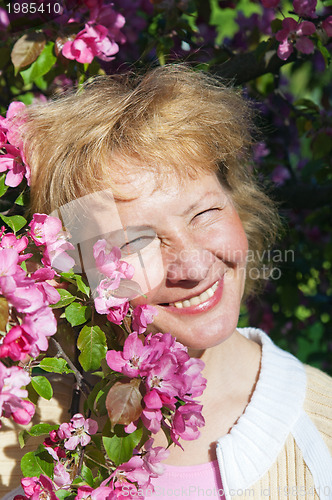 Image of a middle-aged woman in a blossoming magnolias