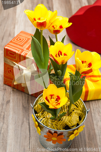 Image of It is red yellow tulips and gift boxes, a close up
