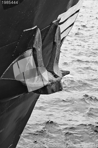 Image of Old rusty anchor at a board of the ship