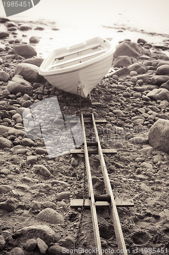 Image of Fishing boat on stony to seacoast