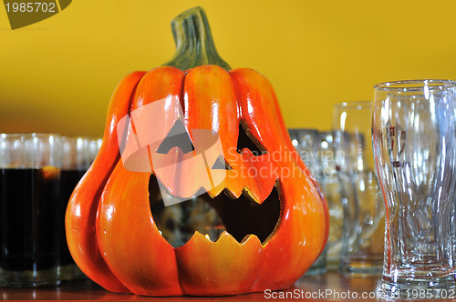 Image of helloween party pumpkin and wine glasses close up