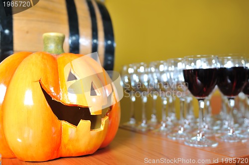 Image of helloween party pumpkin and wine glasses close up