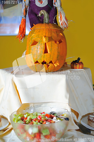 Image of helloween party pumpkin and wine glasses close up