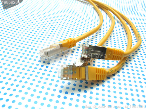 Image of yellow ethernet cable on dotted background