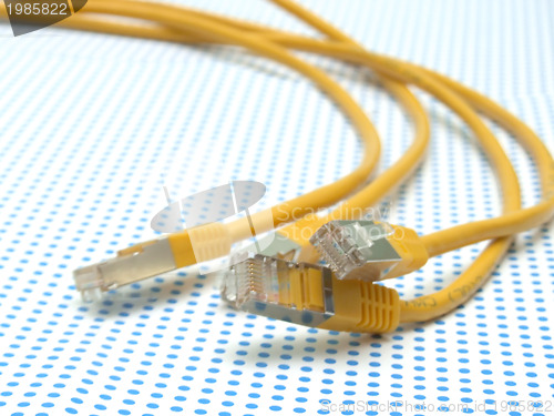 Image of yellow ethernet cable on dotted background