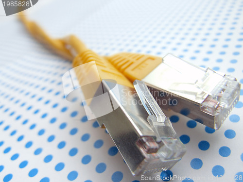 Image of yellow ethernet cable on dotted background