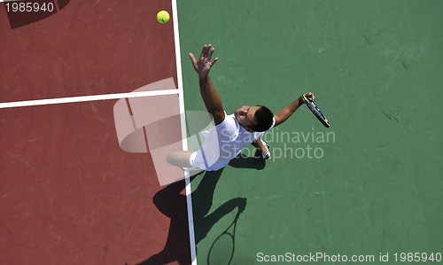 Image of young man play tennis outdoor