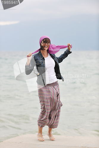 Image of beautiful young woman on beach with scarf