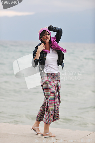 Image of beautiful young woman on beach with scarf