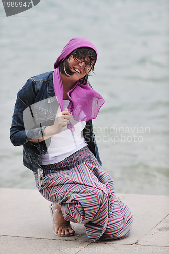 Image of beautiful young woman on beach with scarf