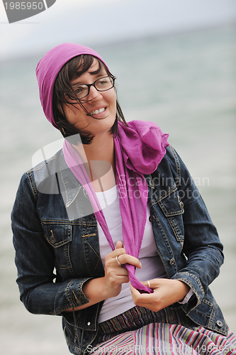 Image of beautiful young woman on beach with scarf