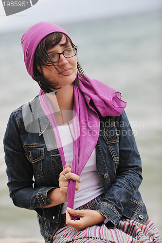 Image of beautiful young woman on beach with scarf