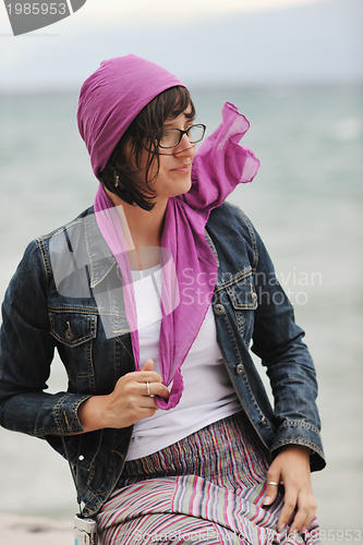 Image of beautiful young woman on beach with scarf