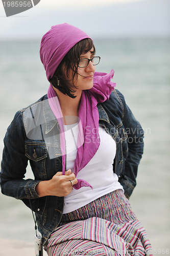 Image of beautiful young woman on beach with scarf