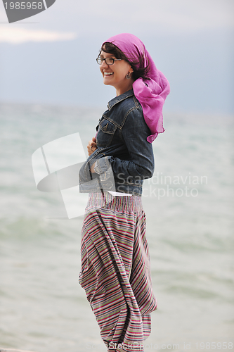 Image of beautiful young woman on beach with scarf