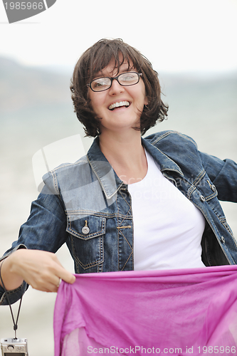 Image of beautiful young woman on beach with scarf