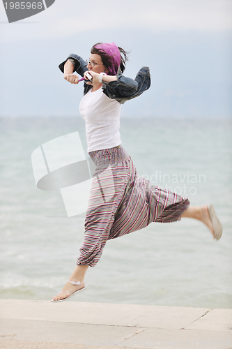 Image of beautiful young woman on beach with scarf