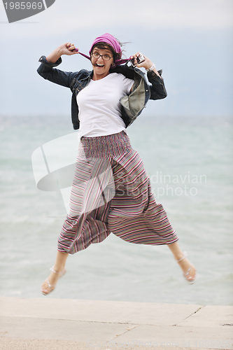 Image of beautiful young woman on beach with scarf