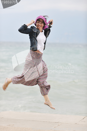 Image of beautiful young woman on beach with scarf