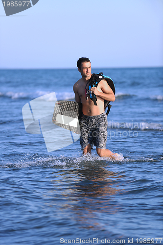 Image of Portrait of a young  kitsurf  man at beach on sunset